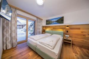 Ένα ή περισσότερα κρεβάτια σε δωμάτιο στο Nationalpark Chalet Keeskogel