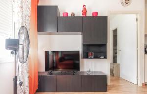 a living room with a black entertainment center at Pet Friendly Apartment In Torremolinos in Torremolinos