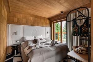 a bedroom with a bed and a window at IJG Imperial Apartamenty Smrekowa in Zakopane
