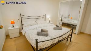 a bedroom with a large bed with two pillows on it at Villarios Castello in Villarios