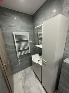 a small bathroom with a sink and a toilet at Apartmani Žaneta in Kaštela +49 photos