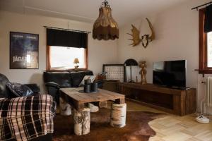 a living room with a couch and a table at Lansån 46 Guesthouse in Krokfors