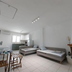 a living room with two couches and a table at Olive Tree Villa in Nikiti