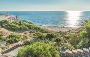 a view of a beach with a house and the ocean at Casa Mare in Magomadas