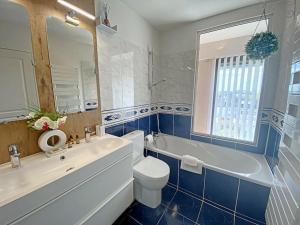 a bathroom with a tub and a toilet and a sink at RÉF 353 appartement duplex Lorient centre in Lorient +28 photos