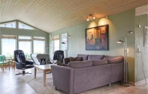 a living room with a couch and a table at Bakkely in Brønde