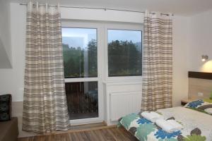 Posteľ alebo postele v izbe v ubytovaní Guest House Vila Pod Lesom