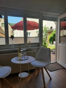 a room with a table and two chairs and a window at Mosel statt Mallorca in Mesenich +11 photos