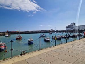 a group of boats are docked in a harbor at Double Room - Folkestone Harbour in Kent