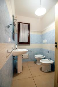 a bathroom with a sink and a toilet and a mirror at Villarios Castello in Villarios +36 photos