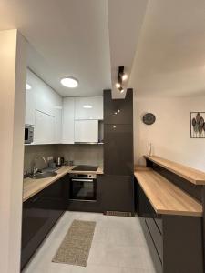 ティヴァトにあるLuxury apartments A&Nの白と黒のキャビネットとシンク付きのキッチン