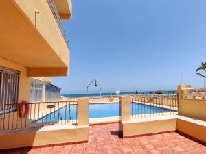 a balcony with a swimming pool and the ocean at Apartamento Gandia Bellreguard 3000 in Bellreguart +17 photos