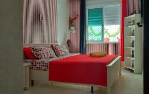 a bedroom with a bed with a red blanket at StayHere, Nice Apartment with Garden and sea view, 1 min walk From Beach, High-Speed WI-FI in El Jadida