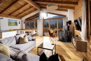 a living room with a couch and a table at Nationalpark Chalet Blindis in Neukirchen am Großvenediger