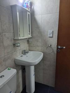 a bathroom with a sink and a toilet at Remedios de Escalada suite 2 pb in Villa María