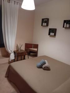 a bedroom with a bed and a chair and a window at La casetta di Ste in Pigna