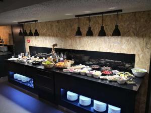a buffet line with many food items on at Brit Hotel Montpellier Eurom&eacute;decine in Montpellier