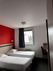 a hotel room with two beds and a window at Brit Hotel La Ferté sous Jouarre in La Ferté-sous-Jouarre