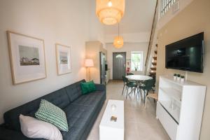 a living room with a couch and a table at Mälarhusen Semesterby Österlen - Stugor & Gårdssviter in Sandby