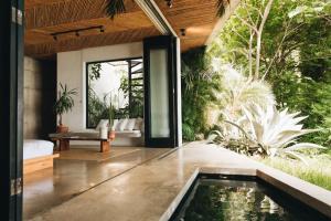 a house with a pool in the middle of a garden at Mint Santa Teresa - Adults only in Santa Teresa Beach +32 photos