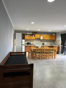 a kitchen and dining room with a table and chairs at El Quincho in Lobos