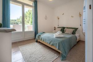 Postelja oz. postelje v sobi nastanitve Loft des Crêtes vue mer