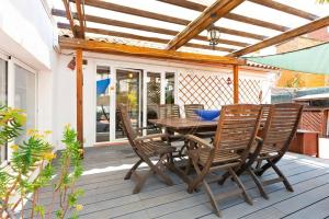 une table et des chaises en bois sur une terrasse dans l'établissement Apartamento con Terraza en Poble Sec, à Barcelone