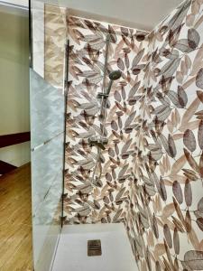 a shower in a room with a mosaic wall at Valpolicella RIVER in Ponton +21 photos