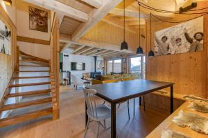 a dining room and living room with a table and chairs at Homency - Résidence de l'Alpe 308 in L'Alpe-d'Huez