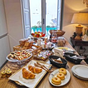 a table topped with lots of different types of pastries at Bed and Breakfast Casa Gioconda in Gaeta