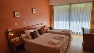 Voodi või voodid majutusasutuse Brit Hotel Du Ban toas