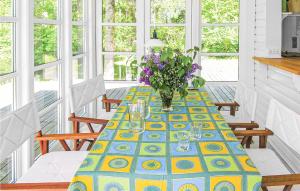 a dining room table with a vase of flowers on it at Holiday Home Stængestykket in Udsholt Sand