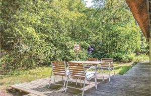 a table and chairs sitting on a wooden deck at Holiday Home Stængestykket in Udsholt Sand