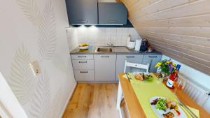 a small kitchen with a table with a plate of food on it at Skyloft Seeliebe in Markelfingen
