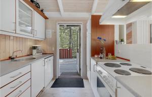 a kitchen with a sink and a stove top oven at Godt Gemt in Vester Sømarken