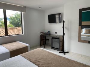 En eller flere senger på et rom på Hotel Plaza Real Ocaña