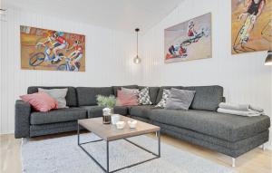 a living room with a couch and a table at Holiday Home Havrebakken in Vester Sømarken