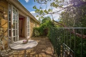 a small patio with a table and a window at West Compton Manor in Dorchester