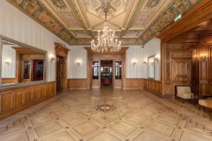 a large room with a ceiling and a chandelier at The Benjamin House in Rīga