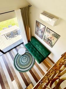 a living room with a green couch and a table at Laimingi namai in Palanga