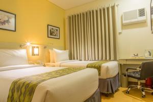 Postel nebo postele na pokoji v ubytování Hamersons Hotel Cebu