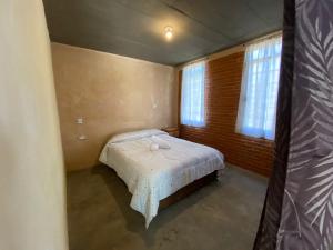 a small bedroom with a bed in a room at Cabaña Abigel in Zacatlán