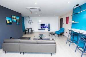 a living room with a couch and a table at Bankable Roomzzz in Accra