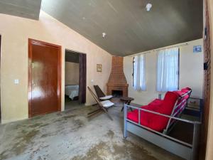 a living room with a red couch and a fireplace at Cabaña Abigel in Zacatlán