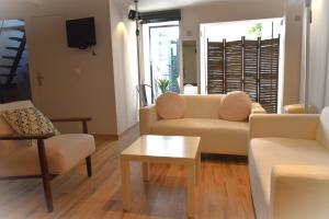 a living room with a couch and chairs and a table at Villa Le Loft by Festif Azur 4-Star 200m2 House with Garden, 5-Min Walk to Palais des Festivals and Beaches in Cannes