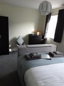a bedroom with a bed with two robes on it at Freda's Treasure "Freddie's Room" in Par