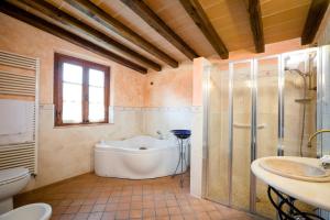 a bathroom with a tub and a toilet and a sink at Fattoria Sant'Andrea - Farm Stay in San Gimignano +45 photos