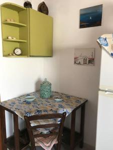 a table in a kitchen with a green cabinet at Koralia Summer House in Lióta +36 photos