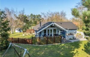 a house with a fence in the yard at Holiday Home Rødby - 08 in Kramnitse +17 photos