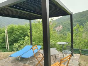 a patio with a table and chairs and a view of the mountains at Ca Giacomo in Tresana